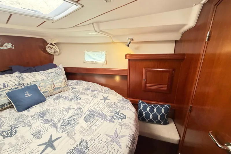 Slide: The Image of Cozy cabin interior of 2006 Beneteau 423 sailboat with nautical-themed bedding. - 46