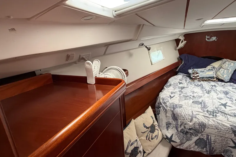 Slide: The Image of Cozy cabin interior of 2006 Beneteau 423 sailboat with nautical-themed bedding. - 46