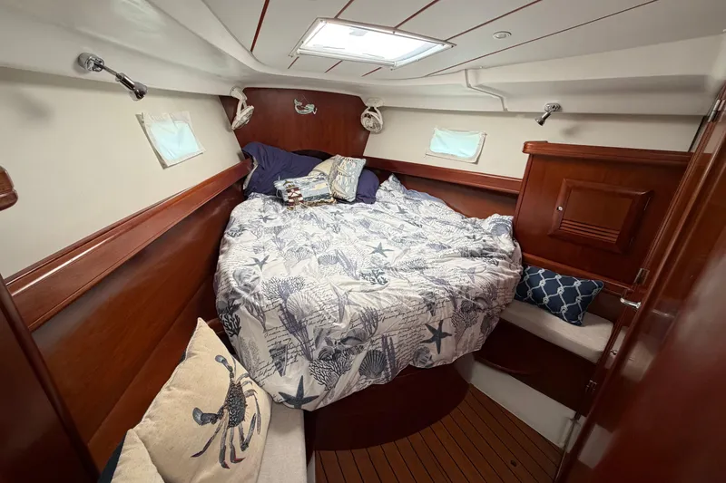 Slide: The Image of Cozy cabin interior of 2006 Beneteau 423 sailboat with nautical-themed bedding. - 48
