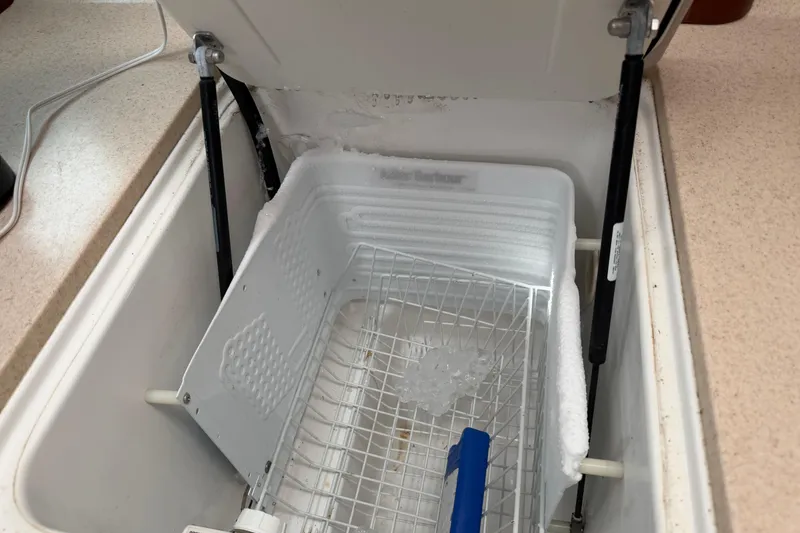 Slide: The Image of Open freezer compartment on 2006 Beneteau 423 yacht, showing interior with ice buildup. - 36