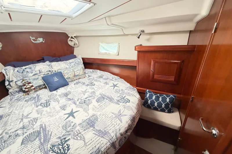 Slide: The Image of Cozy cabin interior of 2006 Beneteau 423 yacht with nautical-themed bedding. - 45