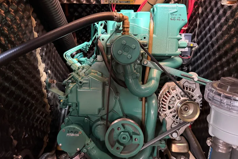 Slide: The Image of Engine of a 2006 Beneteau 423 sailboat, showcasing mechanical components. - 54