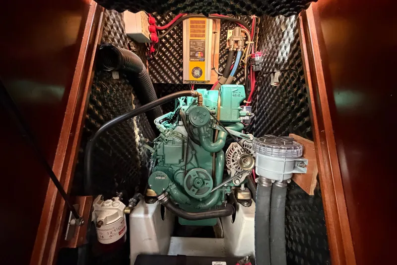 Slide: The Image of Engine compartment of a 2006 Beneteau 423 sailboat, showcasing mechanical components and wiring. - 53