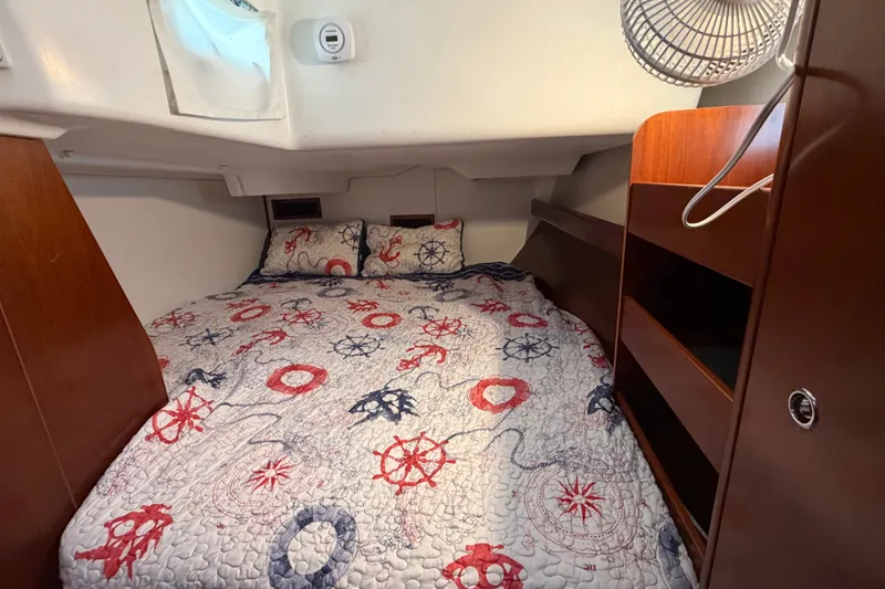 Slide: The Image of Cozy cabin interior of 2006 Beneteau 423 sailboat with nautical-themed bedding. - 50