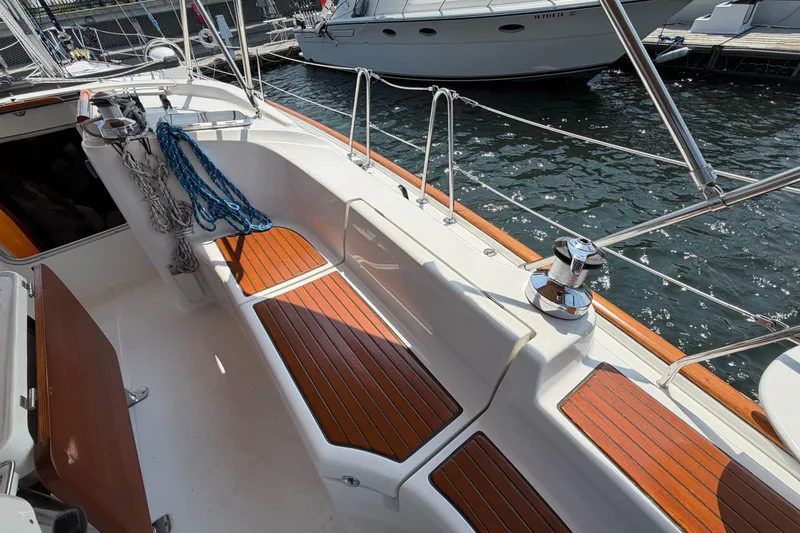 Slide: The Image of 2006 Beneteau 423 sailboat cockpit with wooden seating and nautical ropes. - 11