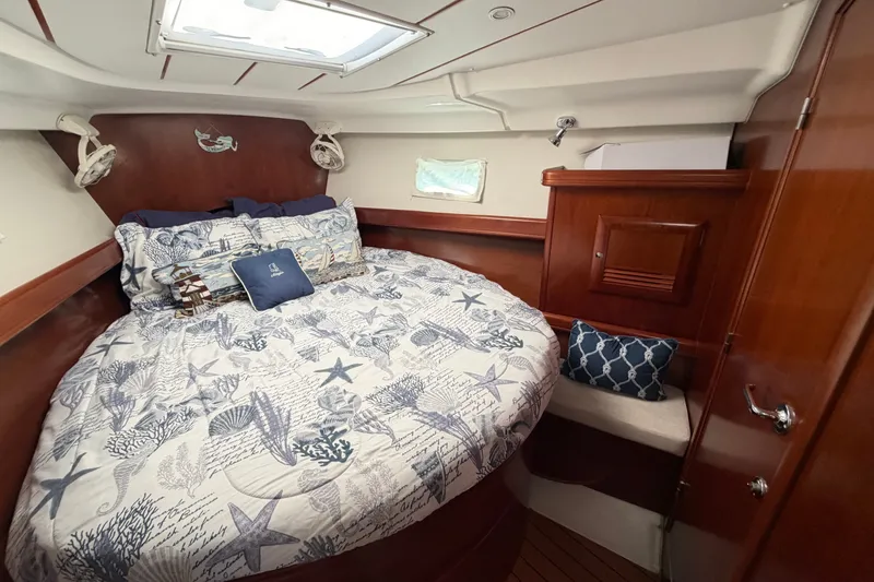 Slide: The Image of Cozy cabin interior of 2006 Beneteau 423 sailboat with nautical-themed bedding. - 44