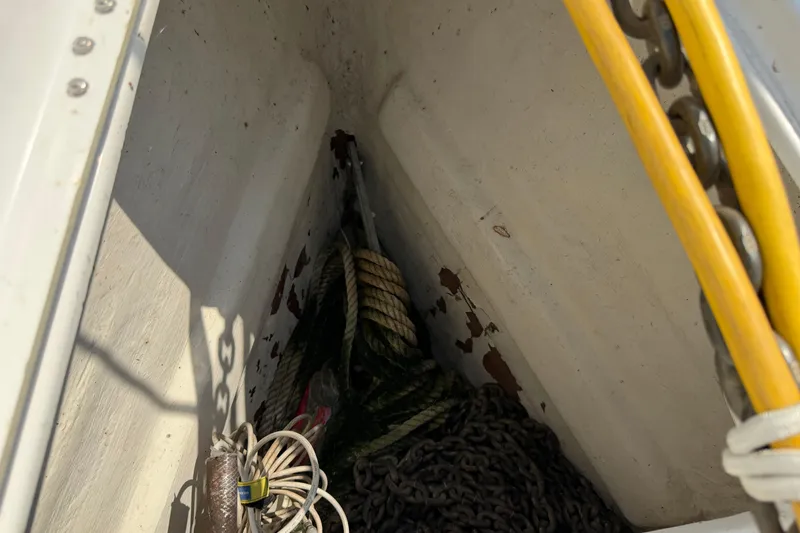 Slide: The Image of Anchor locker of a 2006 Beneteau 423 sailboat with ropes and chains. - 24