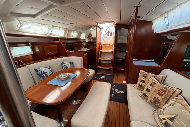 Slide: The Image of Luxurious interior of a 2006 Beneteau 423 yacht with elegant wood finishes and cozy seating. - 42
