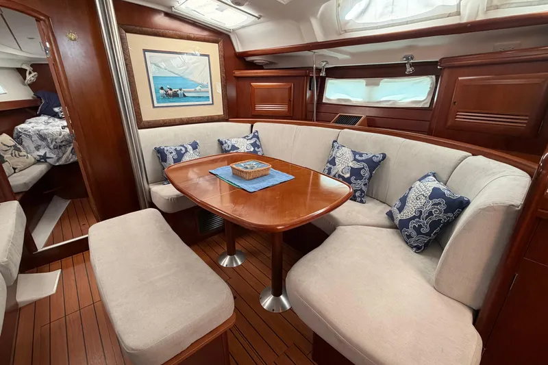 Slide: The Image of Luxurious interior of a 2006 Beneteau 423 yacht with elegant wood finishes and cozy seating. - 38