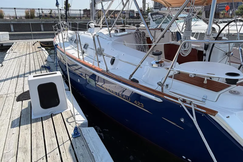 Slide: The Image of 2006 Beneteau 423 sailboat docked at a marina, showcasing sleek design and craftsmanship. - 3