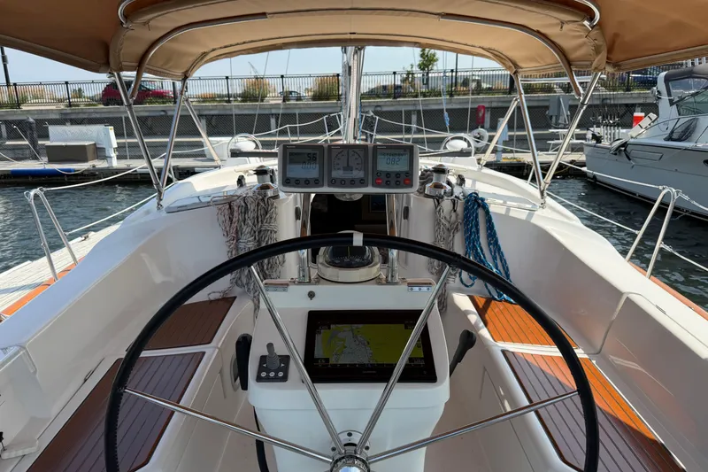 Slide: The Image of Cockpit view of a 2006 Beneteau 423 sailboat with navigation instruments and steering wheel. - 9