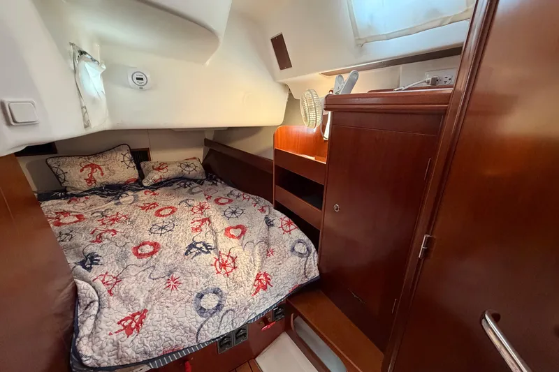 Slide: The Image of Cozy cabin interior of 2006 Beneteau 423 sailboat with nautical-themed bedding. - 43