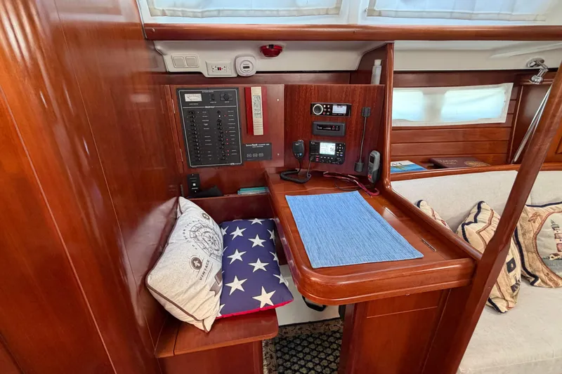 Slide: The Image of Navigation station in 2006 Beneteau 423 yacht with control panel and seating area. - 27