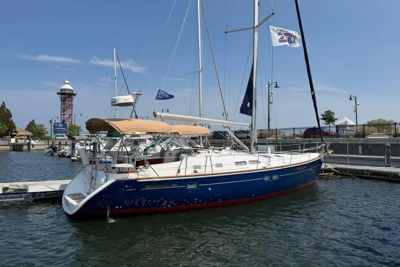 Slide: The Image of 2006 Beneteau 423 sailboat docked at marina with lighthouse in background. - 7