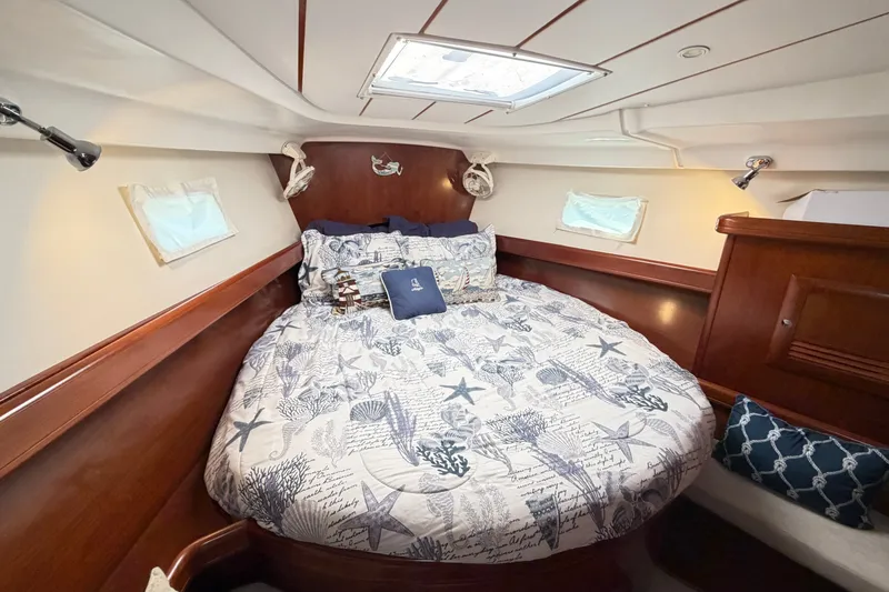 Slide: The Image of Cozy cabin interior of 2006 Beneteau 423 sailboat with nautical-themed bedding. - 43