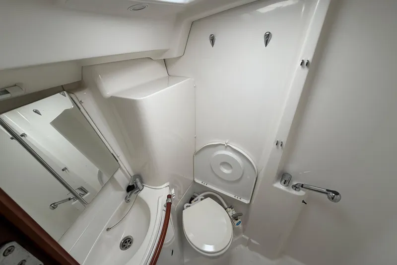 Slide: The Image of Compact bathroom in a 2006 Beneteau 423 yacht, featuring a toilet and sink. - 50