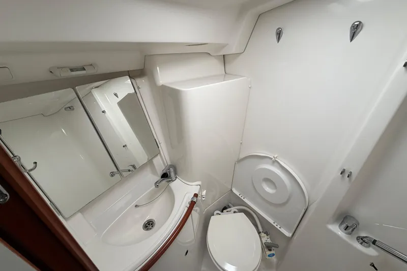 Slide: The Image of 2006 Beneteau 423 yacht bathroom with sink, mirror, and toilet. - 51