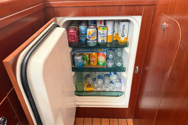 Slide: The Image of Mini fridge stocked with drinks inside a 2006 Beneteau 423 yacht. - 37