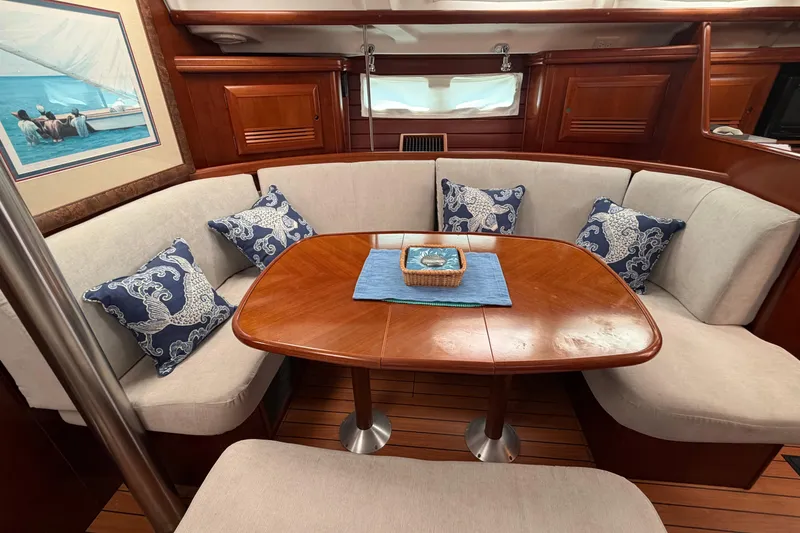 Slide: The Image of Interior of 2006 Beneteau 423 yacht with elegant dining area and nautical-themed cushions. - 39