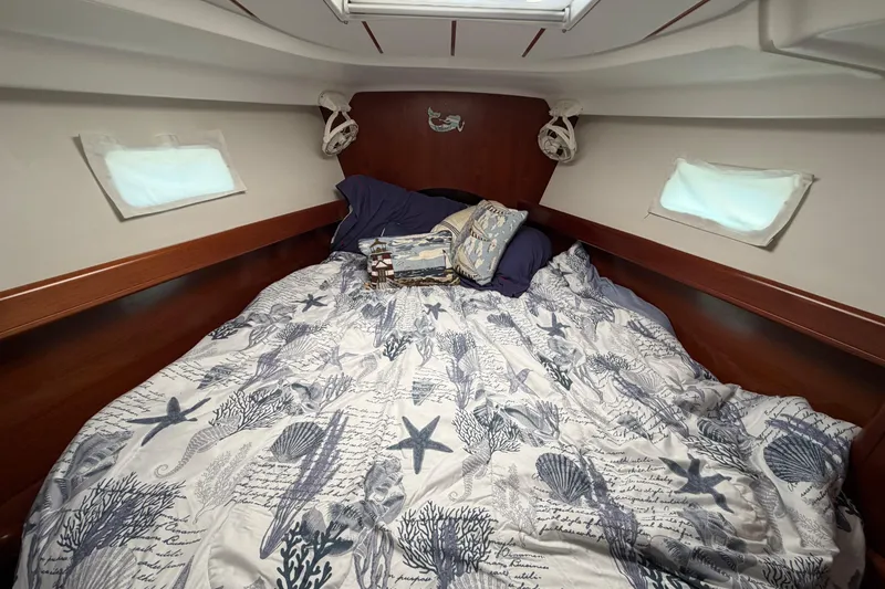 Slide: The Image of Cozy cabin interior of 2006 Beneteau 423 yacht with nautical-themed bedding. - 47