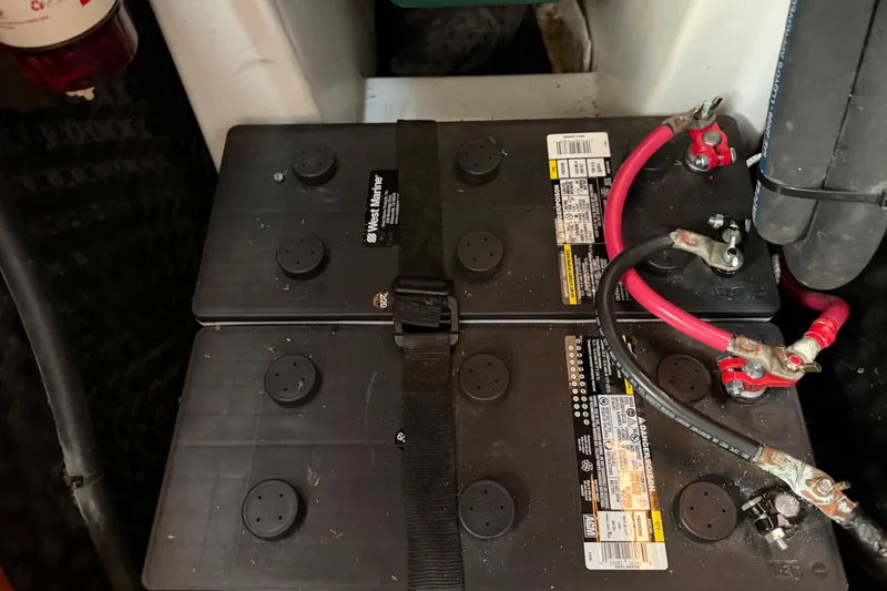 Slide: The Image of Battery compartment of a 2006 Beneteau 423 sailboat with connected cables. - 59