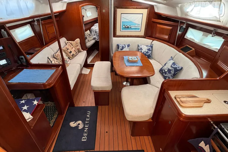 Slide: The Image of Luxurious interior of a 2006 Beneteau 423 sailboat with elegant wood finishes and cozy seating. - 26