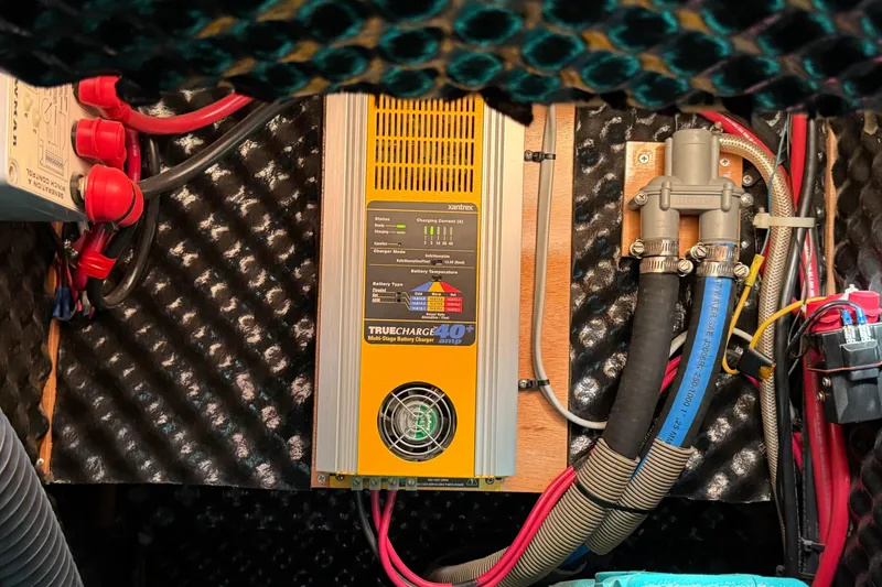 Slide: The Image of Battery charger setup in a 2006 Beneteau 423 sailboat engine compartment. - 52