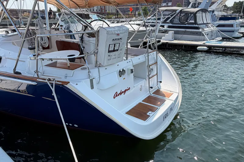 Slide: The Image of Beneteau 423 sailboat, 2006 model, docked at a marina with teak deck accents. - 5