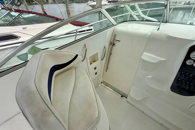 Slide: The Image of The image shows the cockpit of a 2004 Seaswirl Striper 2901 with white seats and control panel. - 15