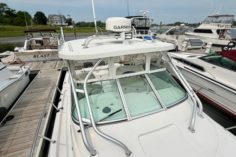 Slide: The Image of A 2004 Seaswirl Striper 2901 docked. It features a Garmin radar on the roof. - 13