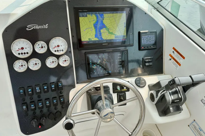 Slide: The Image of The image shows the helm of a 2004 Seaswirl Striper 2901 with navigation system and instruments. - 18
