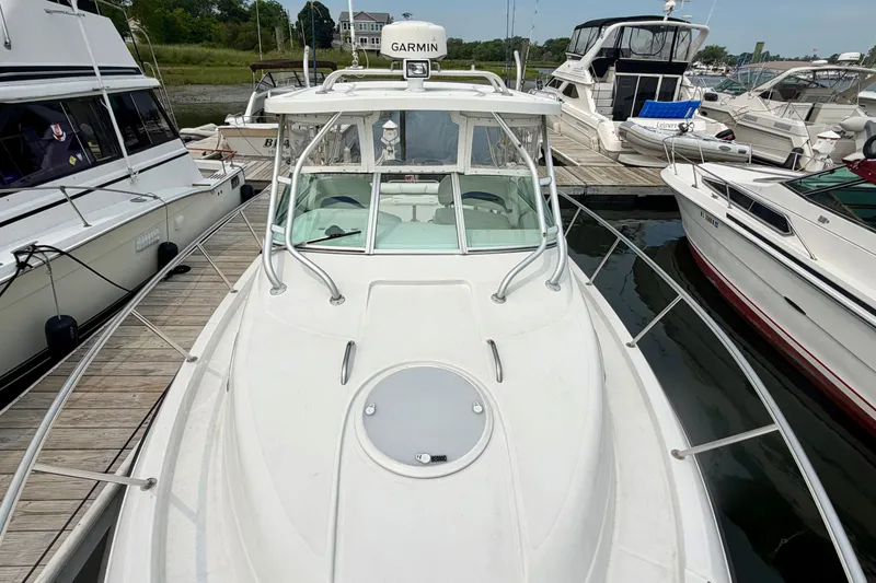 Slide: The Image of A 2004 Seaswirl Striper 2901 docked, surrounded by other boats. - 12