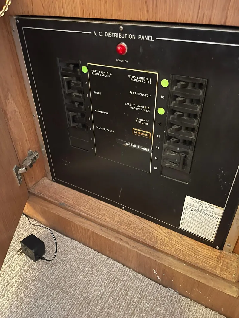 Slide: The Image of A.C. distribution panel on 1995 Hatteras 52 Motor Yacht, showing circuit breakers and controls. - 19