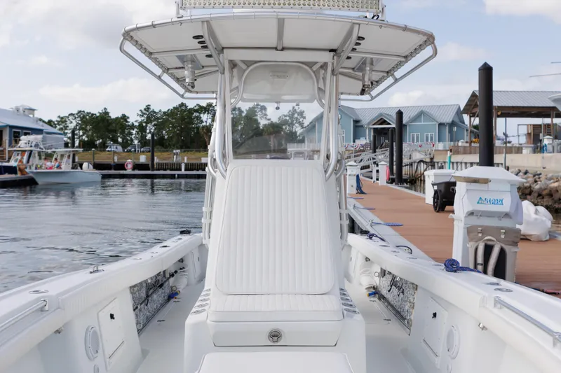 Slide: The Image of 2009 Yellowfin 29 Offshore boat docked at marina, showcasing sleek design and spacious deck. - 13