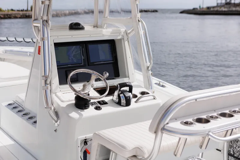 Slide: The Image of 2009 Yellowfin 29 Offshore boat helm with dual screens and steering wheel. - 12