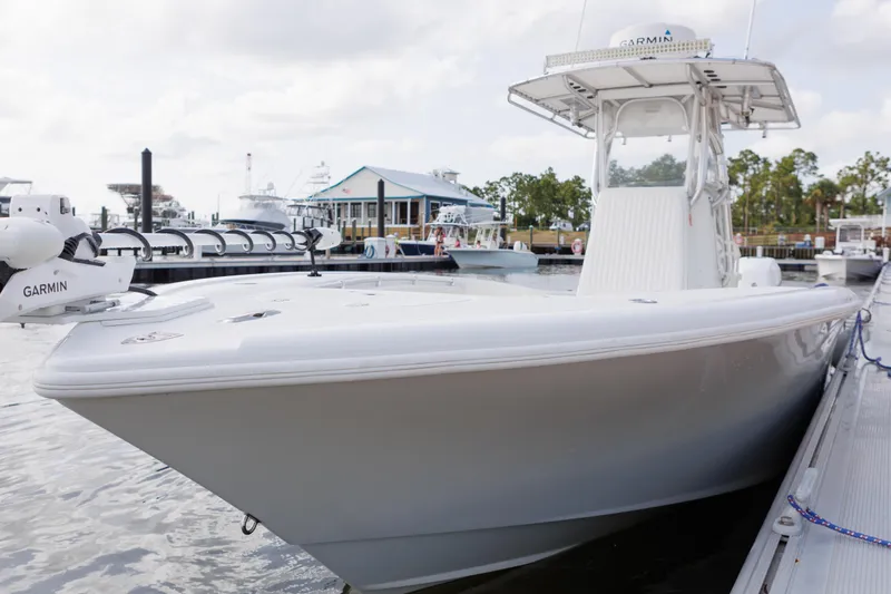 Slide: The Image of 2009 Yellowfin 29 Offshore boat docked, featuring Garmin equipment, with marina background. - 10