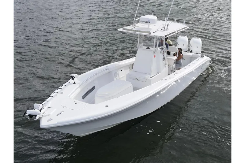 Slide: The Image of 2009 Yellowfin 29 Offshore boat on water, featuring dual engines and Garmin equipment. - 6