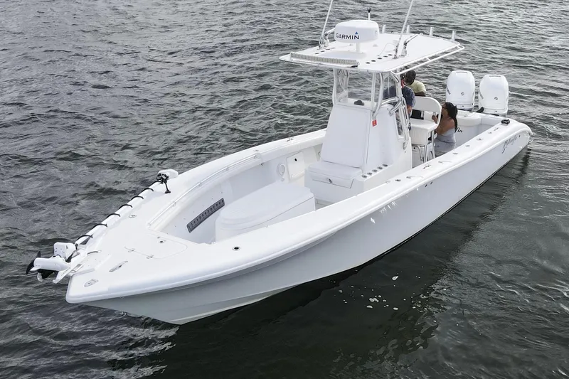 The Image of 2009 Yellowfin 29 Offshore boat on water, featuring dual engines and a center console. - 0