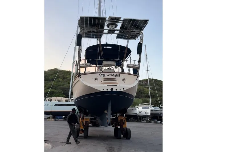 Slide: The Image of Island Packet 370 sailboat from 2004 on a trailer, featuring solar panels and nautical design. - 42