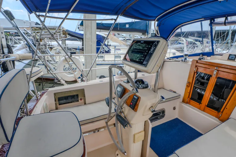 Slide: The Image of Cockpit of a 2004 Island Packet 370 sailboat with navigation equipment and seating. - 26
