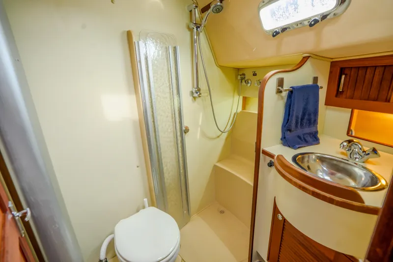 Slide: The Image of Island Packet 370 2004 yacht bathroom with shower, sink, and toilet. - 18