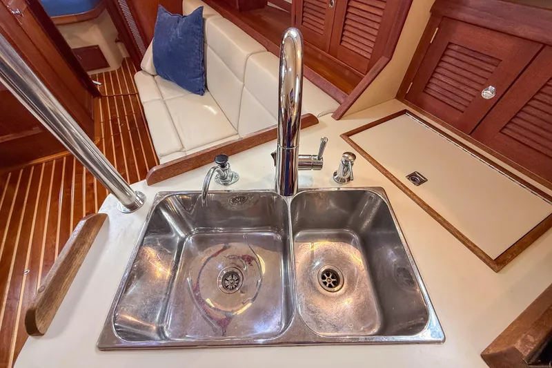 Slide: The Image of Stainless steel sink in 2004 Island Packet 370 yacht kitchen with wooden cabinetry. - 12