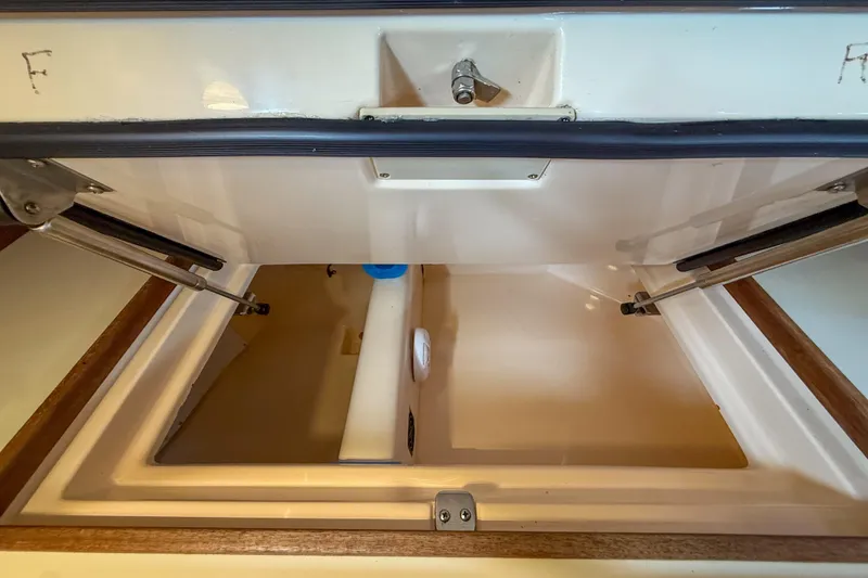 Slide: The Image of Open storage compartment on a 2004 Island Packet 370 sailboat, showcasing interior details. - 13