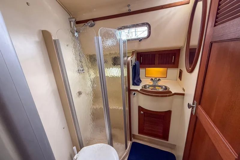 Slide: The Image of Luxurious bathroom interior of 2004 Island Packet 370 yacht with shower and sink. - 19