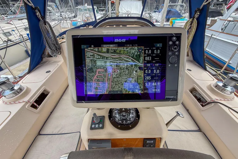 Slide: The Image of Cockpit of 2004 Island Packet 370 sailboat with navigation display and controls. - 24