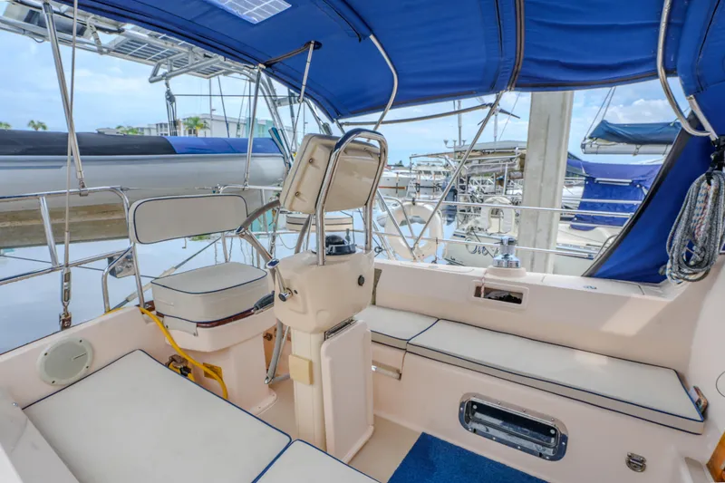 Slide: The Image of Cockpit of 2004 Island Packet 370 sailboat with blue canopy and seating. - 30