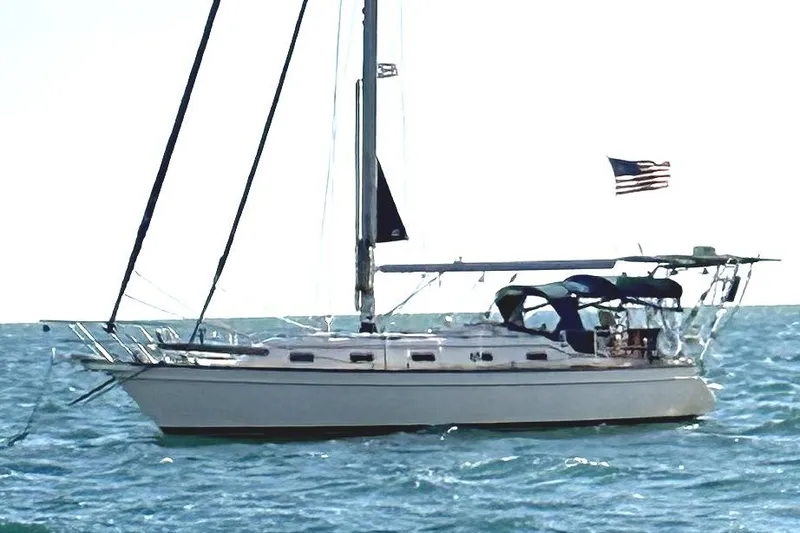 Slide: The Image of Sailing yacht Island Packet 370, 2004 model, cruising on open water with American flag. - 44