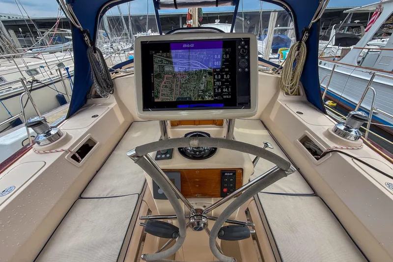 Slide: The Image of Cockpit of 2004 Island Packet 370 sailboat with navigation display and steering wheel. - 23