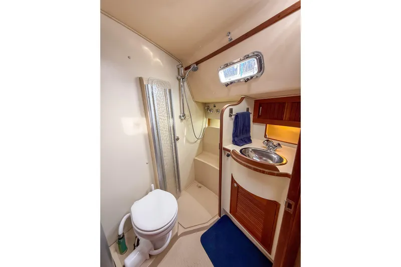 Slide: The Image of 2004 Island Packet 370 yacht bathroom with shower, sink, and toilet. - 20