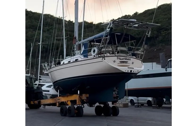 Slide: The Image of Island Packet 370 sailboat from 2004 on a trailer in a marina setting. - 41